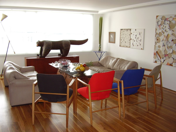 Interior Architecture: Diego Correa. Interior Design: Pedro Tagliafico. Even when art fulfil many times a decorative purpose as this could be the case due the harmonious colour scheme between space, furniture and art, in this case it tells us how an art proposal carefully arranged not just finish to shape the character of a space but make it unique as it is a reflexion of the ideas and interests of the owner.